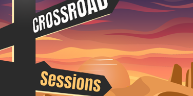 A directional sign at a crossroads reading 'Crossroad Sessions: Room 218'