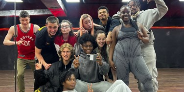 Cast of Channel 4 show Dreamers group selfie in a dance studio with a mirrored wall